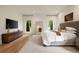 Bright main bedroom featuring hardwood floors, a large window, and a modern style at 4132 Carmain Ne Dr, Atlanta, GA 30342