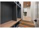 A mudroom featuring gray shelving, a wooden bench, and a view of the staircase at 4132 Carmain Ne Dr, Atlanta, GA 30342