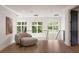 Relaxing sitting area with cozy armchair and large windows offering scenic views at 4132 Carmain Ne Dr, Atlanta, GA 30342