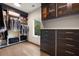 Spacious walk-in closet with custom built-ins, cabinetry, a large window, and wood flooring for ample storage at 4132 Carmain Ne Dr, Atlanta, GA 30342