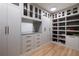 Custom walk-in closet with built-in shelving, cabinets, drawers, and stylish hardware for organization and storage at 4132 Carmain Ne Dr, Atlanta, GA 30342