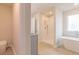 Bathroom showcasing a standalone tub, a separate shower, and neutral tiling at 250 Crabapple Rd, Mcdonough, GA 30253