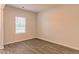 Well-lit bedroom featuring wood flooring and a large window at 250 Crabapple Rd, Mcdonough, GA 30253
