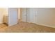 A cozy bedroom with neutral carpet and a view of an adjacent room at 250 Crabapple Rd, Mcdonough, GA 30253