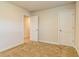 Well-lit bedroom with neutral carpet and two access doors at 250 Crabapple Rd, Mcdonough, GA 30253