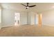 Spacious bedroom with neutral carpet, ceiling fan, and ensuite bathroom entrance at 250 Crabapple Rd, Mcdonough, GA 30253