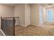Upstairs hallway with neutral carpet and decorative railings leading to bedrooms at 250 Crabapple Rd, Mcdonough, GA 30253