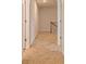 Carpeted hallway leading to the staircase in a home with neutral tones at 250 Crabapple Rd, Mcdonough, GA 30253