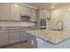 Modern kitchen featuring granite countertops, stainless steel appliances, and sleek gray cabinets at 250 Crabapple Rd, Mcdonough, GA 30253