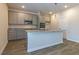 Stylish kitchen with granite countertops, island, stainless steel appliances, and gray cabinets at 250 Crabapple Rd, Mcdonough, GA 30253