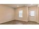 Contemporary living room with wood flooring, neutral walls, window, and exterior door at 250 Crabapple Rd, Mcdonough, GA 30253