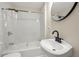 Bathroom featuring a modern sink, a shower with white marble tile, and bright lighting, creating a serene spa-like feel at 2794 7Th Sw St, Atlanta, GA 30315