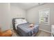 Inviting bedroom offering soft lighting, a plush bed, and a window for natural light creating a calm ambiance at 2794 7Th Sw St, Atlanta, GA 30315