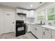 Bright kitchen features white cabinets, a white subway tile backsplash, and stainless steel appliances at 2794 7Th Sw St, Atlanta, GA 30315
