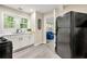 Efficient kitchen with stainless steel appliances, including a black refrigerator and a view to another room at 2794 7Th Sw St, Atlanta, GA 30315
