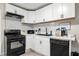 Modern kitchen with white subway tile backsplash, sleek black appliances, and ample counter space for cooking at 2794 7Th Sw St, Atlanta, GA 30315