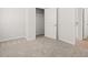 Bedroom view showcasing the closet with shelving, a doorway, and plush carpeting for a comfortable feel at 3048 Manor Hill Pl, Union City, GA 30291