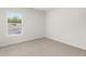 Simple bedroom featuring neutral carpet, light walls, and a window for natural light at 3048 Manor Hill Pl, Union City, GA 30291