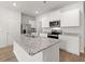 Spacious kitchen featuring an island with granite countertops, stainless steel appliances, and white cabinets at 3048 Manor Hill Pl, Union City, GA 30291