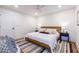 Relaxing bedroom features a ceiling fan, white walls, wood flooring, and a cozy rug at 139 Sisson Ne Ave, Atlanta, GA 30317