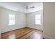 Bright bedroom features hardwood floors, neutral paint, crown molding, ceiling fan, and double-hung windows at 139 Sisson Ne Ave, Atlanta, GA 30317
