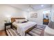 Comfortable bedroom with white walls, wood floors, ceiling fan, ensuite bathroom, and tasteful decor at 139 Sisson Ne Ave, Atlanta, GA 30317