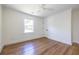 Empty bedroom boasts hardwood floors and a large window to welcome in natural light at 139 Sisson Ne Ave, Atlanta, GA 30317