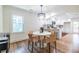 Open-concept dining room with modern light fixture and view of the kitchen at 139 Sisson Ne Ave, Atlanta, GA 30317