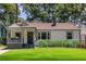 Charming single-story home featuring a cozy front porch, well-manicured lawn, and lush landscaping at 139 Sisson Ne Ave, Atlanta, GA 30317