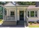 Inviting front porch with seating area and dark front door at 139 Sisson Ne Ave, Atlanta, GA 30317