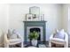 Charming living room with a decorative fireplace and cozy accent chairs at 139 Sisson Ne Ave, Atlanta, GA 30317