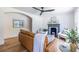 Bright living room features a fireplace, leather couch, hardwood floors and ceiling fan at 139 Sisson Ne Ave, Atlanta, GA 30317