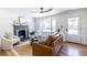 Spacious living room featuring a fireplace, hardwood floors, natural light, and modern decor at 139 Sisson Ne Ave, Atlanta, GA 30317