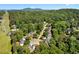 Community aerial view featuring lush greenery, powerlines, neighborhood homes, pond, and the surrounding area at 1661 Duxbury Nw Ln, Kennesaw, GA 30152