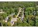 Overhead view of a neighborhood nestled among lush trees with a pond, offering privacy and community at 1661 Duxbury Nw Ln, Kennesaw, GA 30152