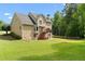 Spacious backyard with lush lawn, wooden deck, patio, and mature trees, perfect for outdoor entertaining at 1661 Duxbury Nw Ln, Kennesaw, GA 30152