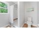 Bright bathroom with a tiled shower, toilet, and artwork on the wall at 1661 Duxbury Nw Ln, Kennesaw, GA 30152