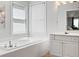 Bright bathroom featuring a soaking tub, vanity, and wood-look flooring at 1661 Duxbury Nw Ln, Kennesaw, GA 30152