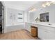 Bright bathroom featuring a soaking tub, double vanity, and wood-look flooring at 1661 Duxbury Nw Ln, Kennesaw, GA 30152