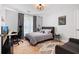 Well lit bedroom features hardwood floors and a unique light fixture at 1661 Duxbury Nw Ln, Kennesaw, GA 30152