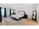 Spacious bedroom featuring neutral walls, ceiling fan, and stylish furniture on wood-look flooring at 1661 Duxbury Nw Ln, Kennesaw, GA 30152