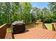 A wooden deck showcases a grill, providing a perfect outdoor cooking and relaxation area at 1661 Duxbury Nw Ln, Kennesaw, GA 30152