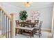 Elegant dining room with a modern chandelier, dining table with seating, light gray walls, and bright natural light at 1661 Duxbury Nw Ln, Kennesaw, GA 30152