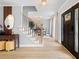 Bright entryway featuring wood-look floors, staircase with black railing, stylish lighting, and an open view to the dining room at 1661 Duxbury Nw Ln, Kennesaw, GA 30152