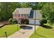 Charming two-story brick home with a well-manicured lawn, basketball hoop, and attached two-car garage at 1661 Duxbury Nw Ln, Kennesaw, GA 30152