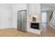 Kitchen area showcasing stainless steel appliances, custom cabinetry, and hardwood flooring at 1661 Duxbury Nw Ln, Kennesaw, GA 30152