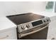 Close up of the stainless steel electric range oven, accented by marble-like backsplash at 1661 Duxbury Nw Ln, Kennesaw, GA 30152