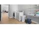Clean laundry room featuring a modern washer and dryer, shelving, and wood-look flooring at 1661 Duxbury Nw Ln, Kennesaw, GA 30152