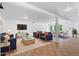 Staged living room with tile floors, recessed lighting, and modern furnishings at 1661 Duxbury Nw Ln, Kennesaw, GA 30152