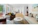 Open-concept living area with hardwood floors, modern furniture, and access to the outdoor deck at 1661 Duxbury Nw Ln, Kennesaw, GA 30152